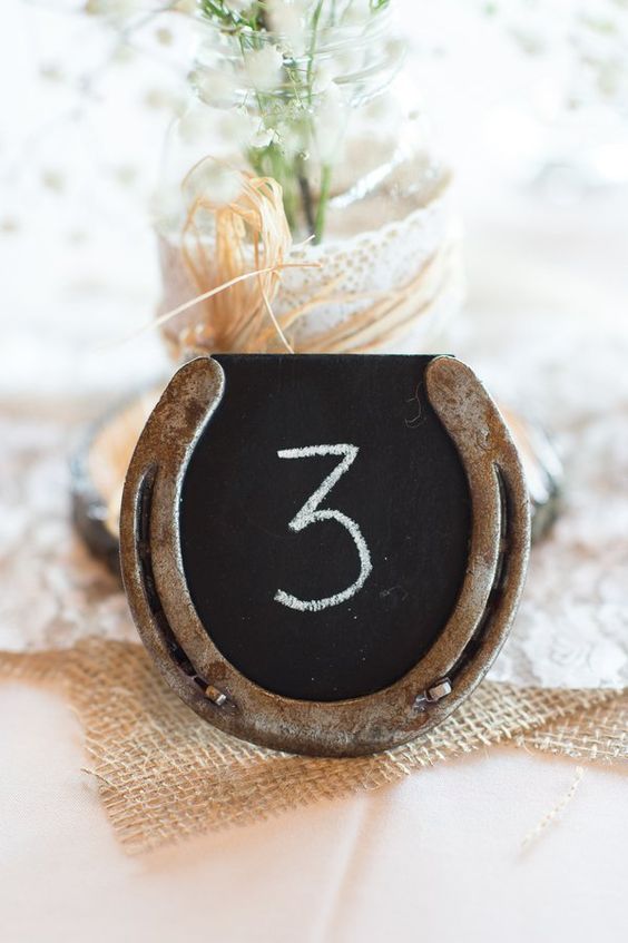 old horseshoe and chalkboard table numbers rustic country wedding centerpiece