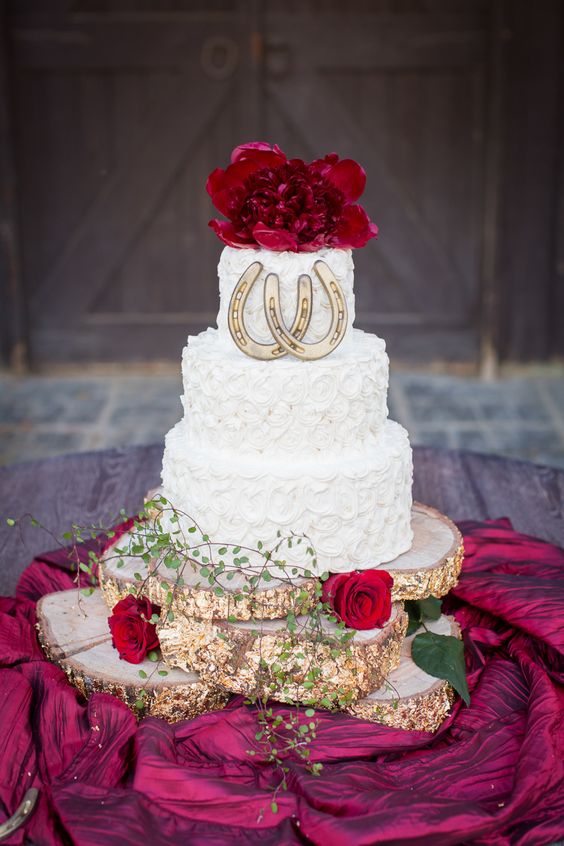 rustic wedding cake with horseshoe details and glitter tree stump