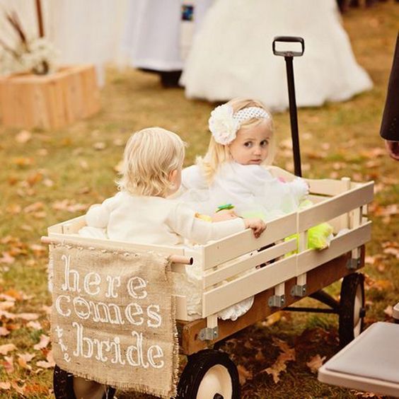 baby flower girl in wagon