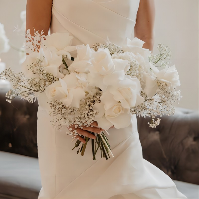 white roses and baby‘s breath wedding bouquet