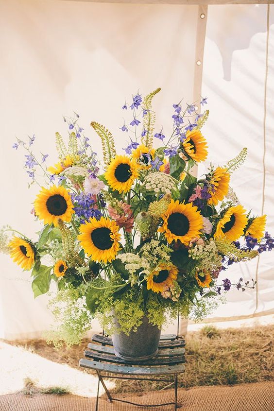 wedding centrepiece of the marquee was a big bucket of sunflowers and wildflowers
