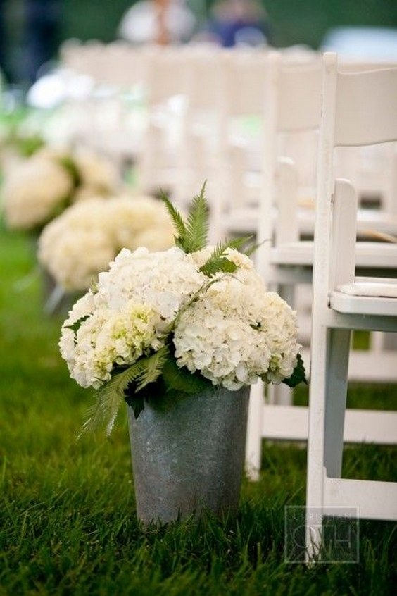 white hydrangeas on bucket wedding aisle