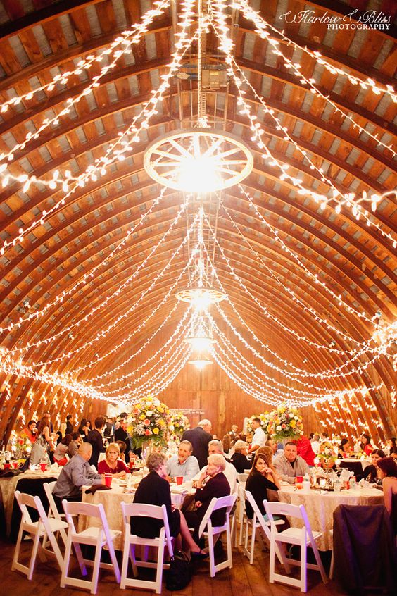 Barn wedding reception with gorgeous lighting decor