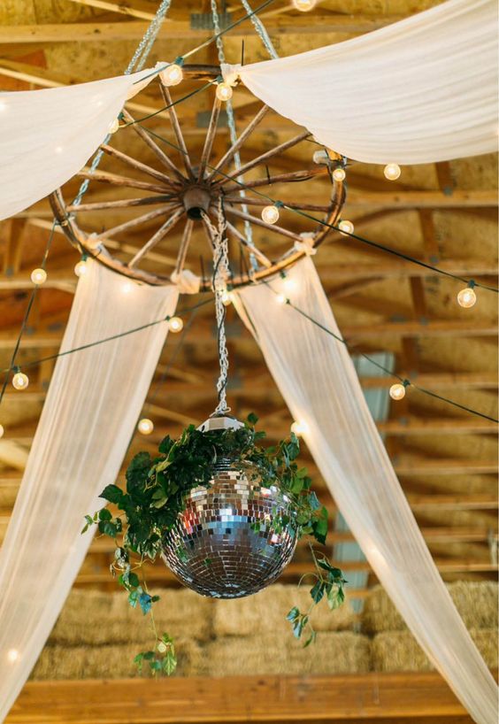 Disco balls and wagon wheels wedding decor ideas for barn wedding