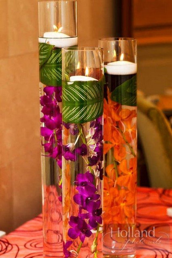 Lovely orchid centerpiece display accented with floating candles