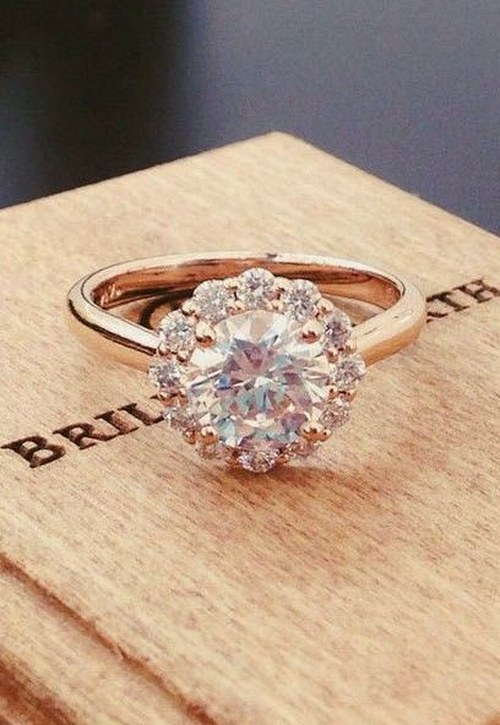 subtle floral diamond halo blooms around the center gem in this exquisite ring via brilliantearth