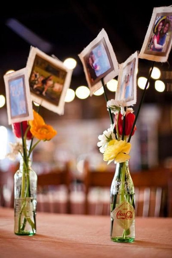 unique way to display photos as beautiful centerpieces at a rustic wedding