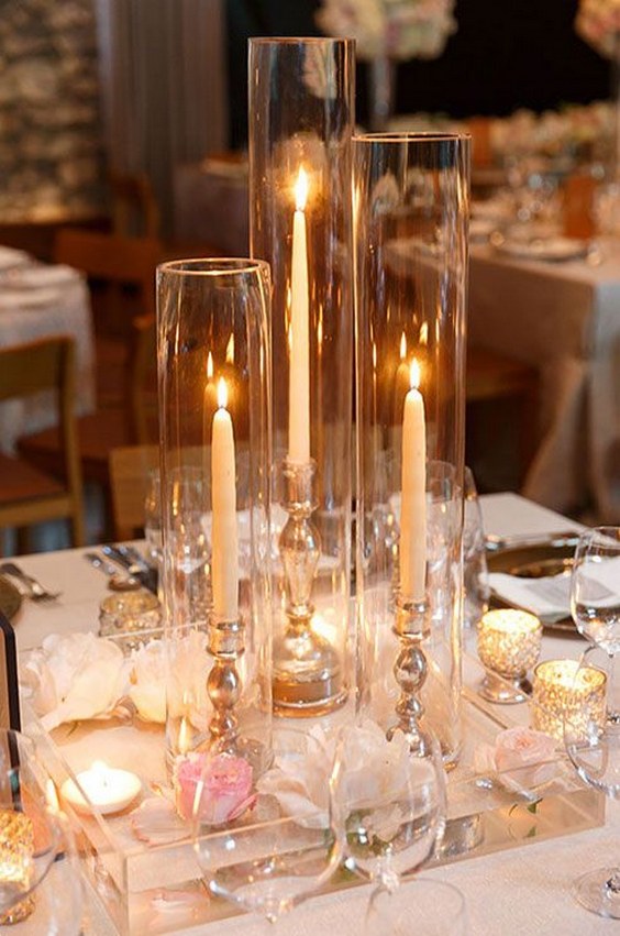 Alternating votive and taper candles wedding centerpiece