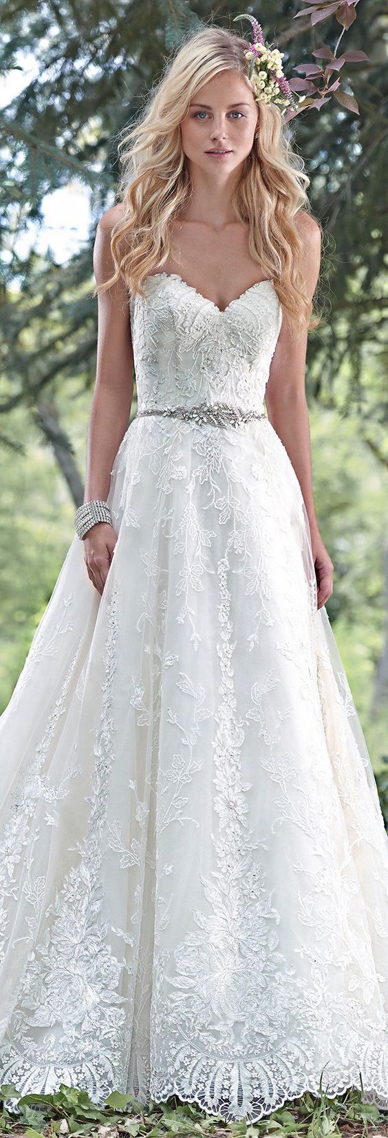 Dreamy lace and tulle combine to create this elegant ball gown wedding dress