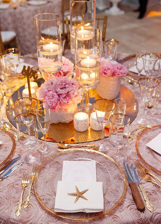 Flowers, starfish, and candlelight wedding centerpiece