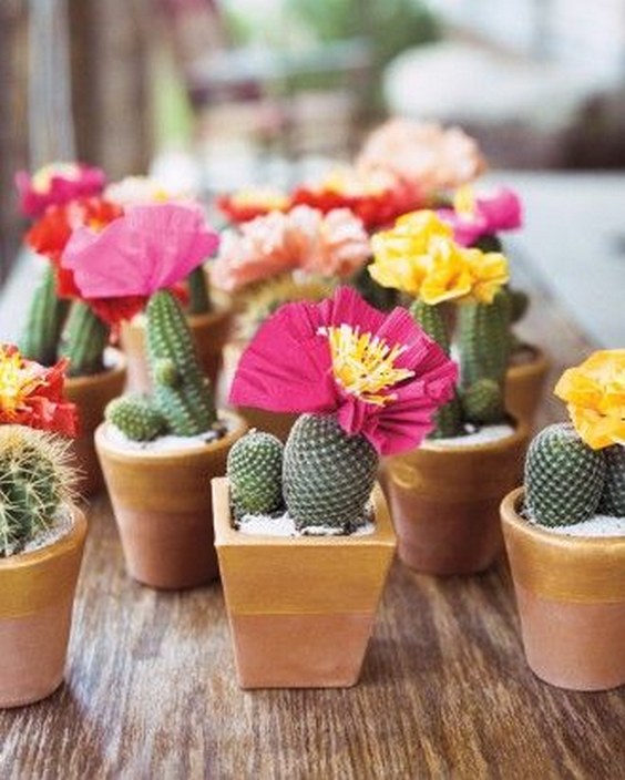 Hand-crafted crepe paper flowers and gold-edged terracotta pots filled with succulents