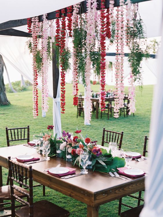Tropical hanging leis wedding table decor via Wendy Laurel