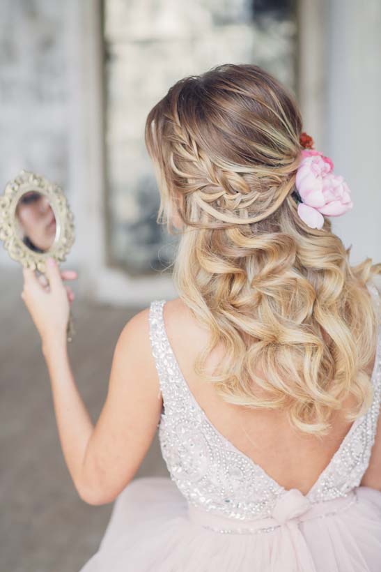 half up half down wedding hairstyle with pink flowers 2 via antonina roman