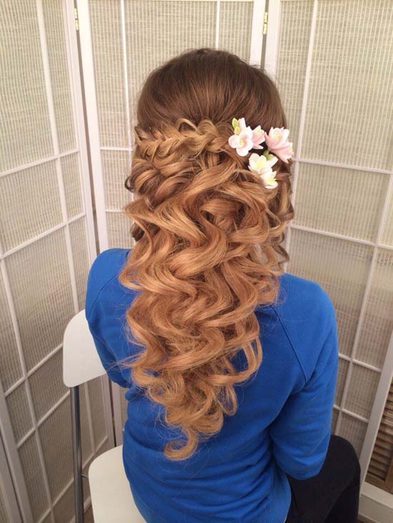 long wavy half up half down wedding hairstyle with pink flowers via antonina roman
