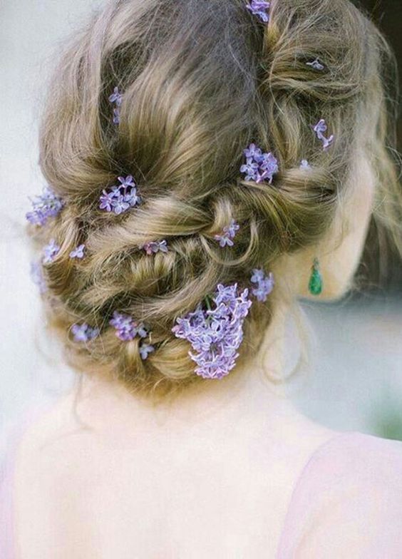 twisted updo wedding hairstyles with purple flowers via Svetlana Fischeva