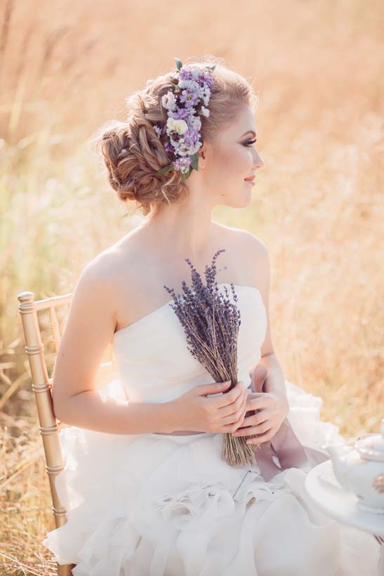 wedding updo hairstyles with lavender flowers via elena radoman