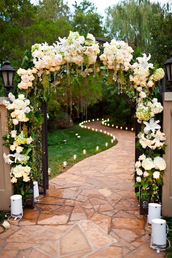 Floral Arch entry to Wedding with Candlelit Path into reception