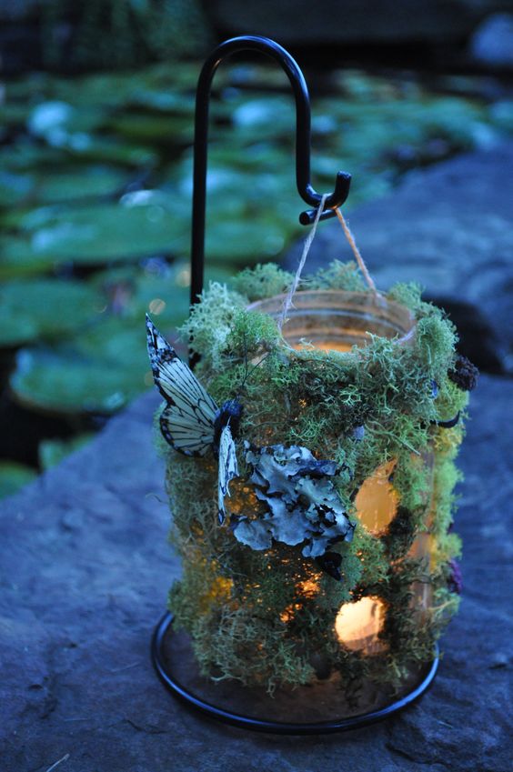 Hanging woodland wedding table number luminaries with moss, lichens & butterflies