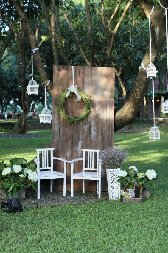 Photo booth backdrop with wood and green elements