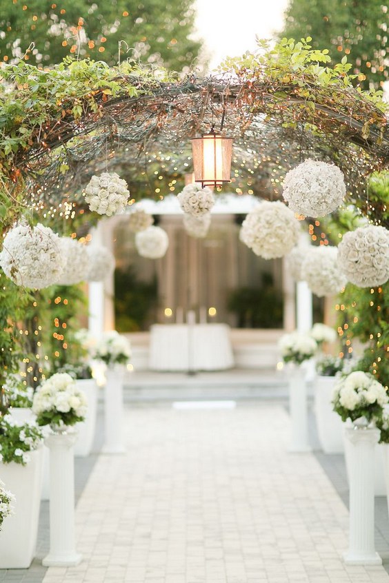 walkway of whimsical branches lights and blooms