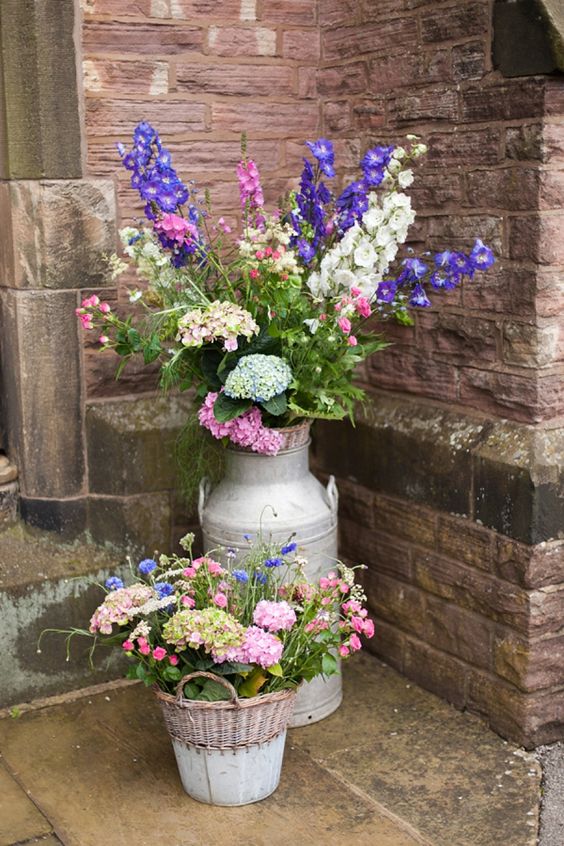 Country garden flowers in a milk churn for a eco friendly wedding