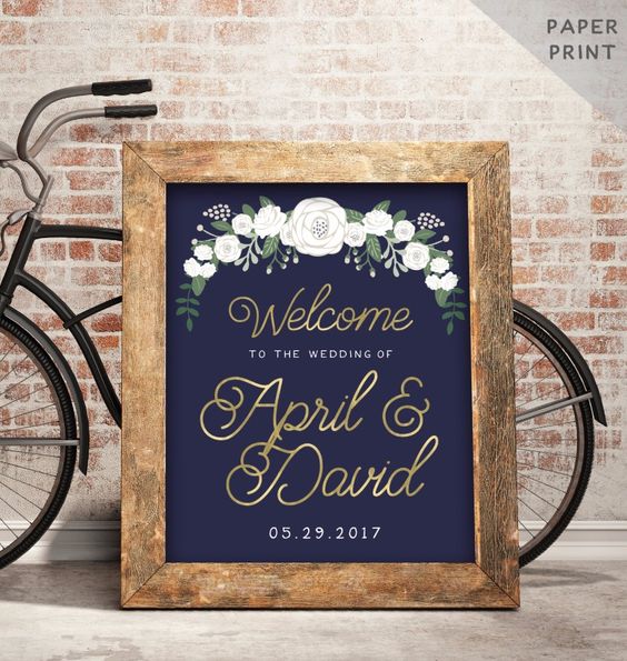 Elegant and dreamy wedding welcome sign with florals in navy and gold