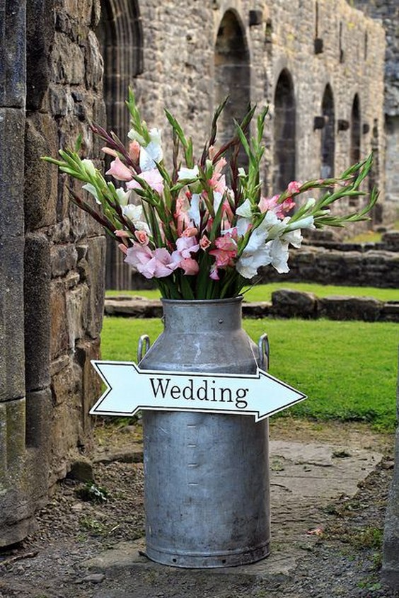 Milk Churns with flowers wedding sign