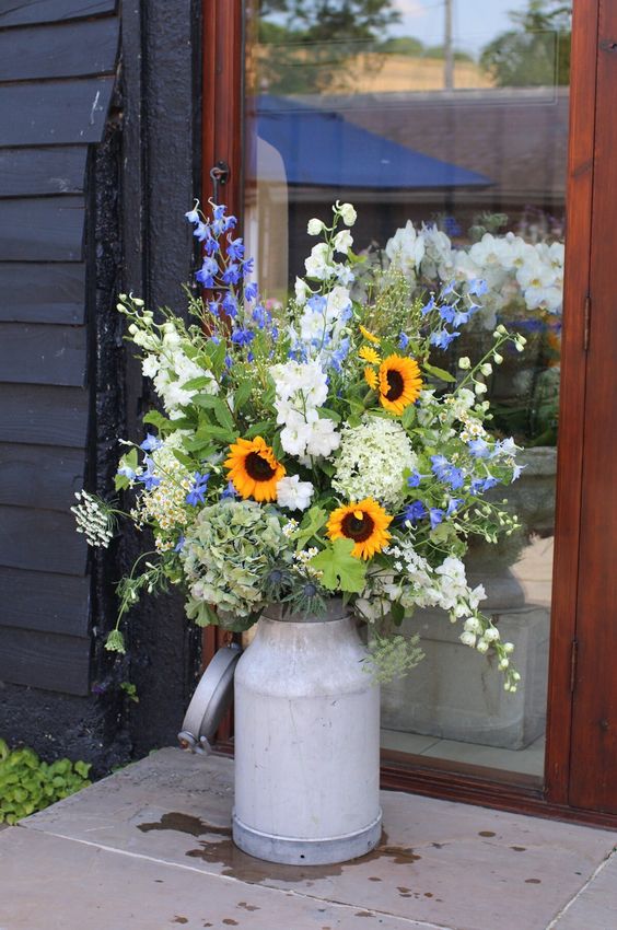 Milk churn arrangements on either side of the ceremony room doors