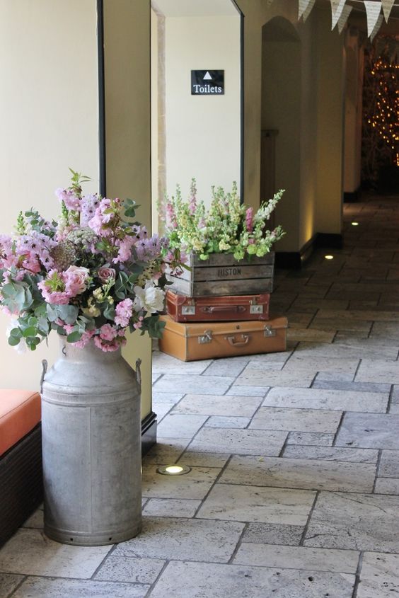 Milk churns and crates with flowers rustic wedding ideas