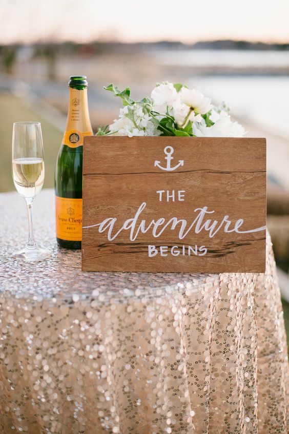 The Adventure Begins sign perfect for a nautical wedding infused with glam