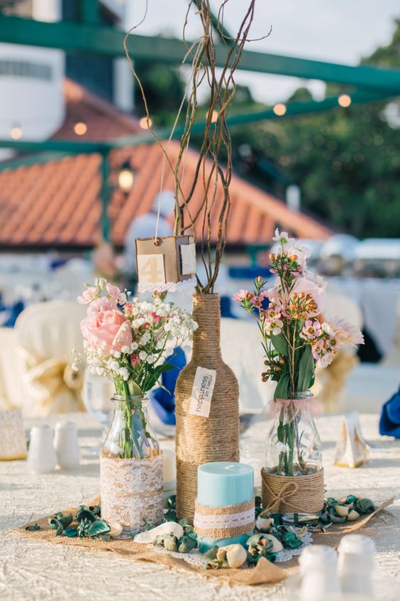 Twine, lace, burlap and mismatched vessels make for infinitely chic table centerpieces