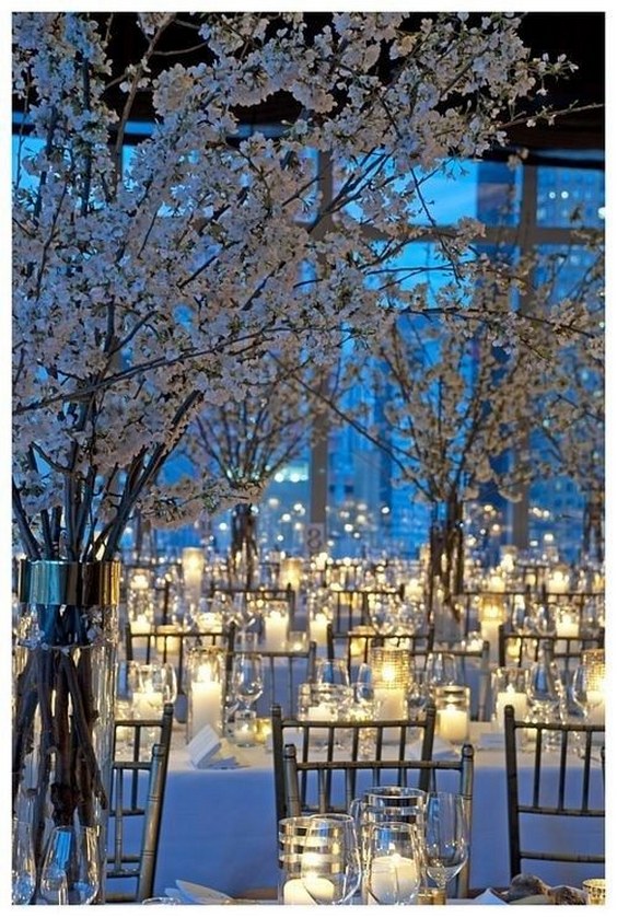 Use candles to light up your venue with white blossomed branches