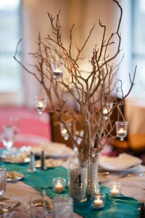 rustic beach candles and tree branches wedding centerpiece