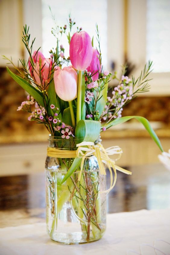 tulips and foliage spring mason jar wedding centerpiece