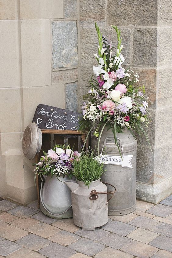 vintage milk churns and flowers wedding decor