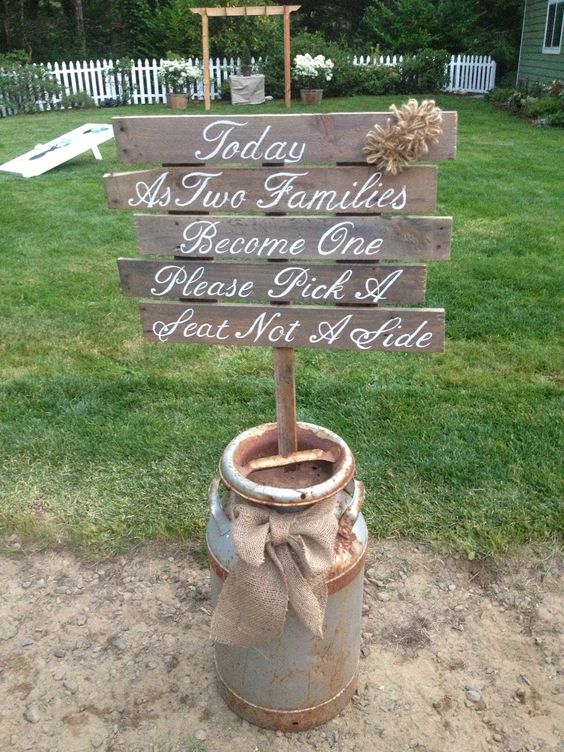 wedding pallet sign with twine flowers, sitting in a milk can with a burlap bow