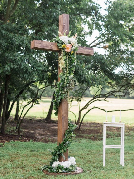 Floral adorned cross for a garden inspired wedding ceremony