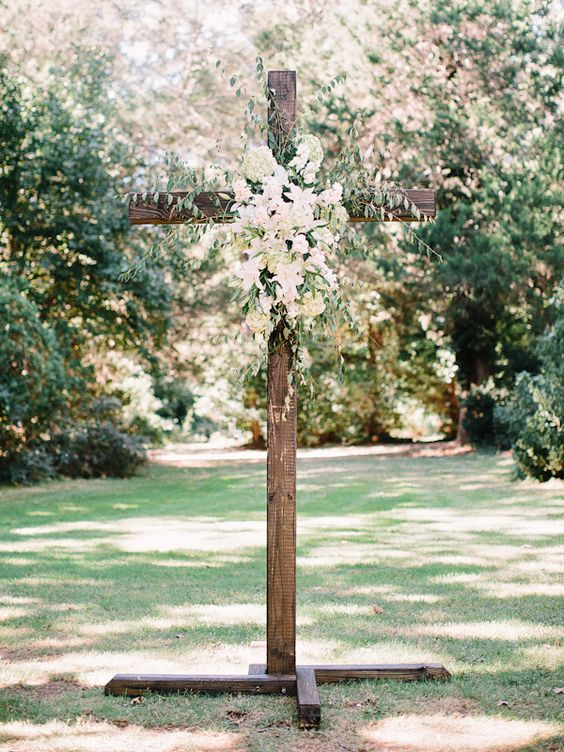 Floral adorned cross for spring wedding ceremony