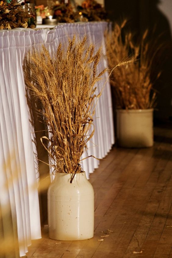 Rustic wheat milk churn wedding backdrop decor