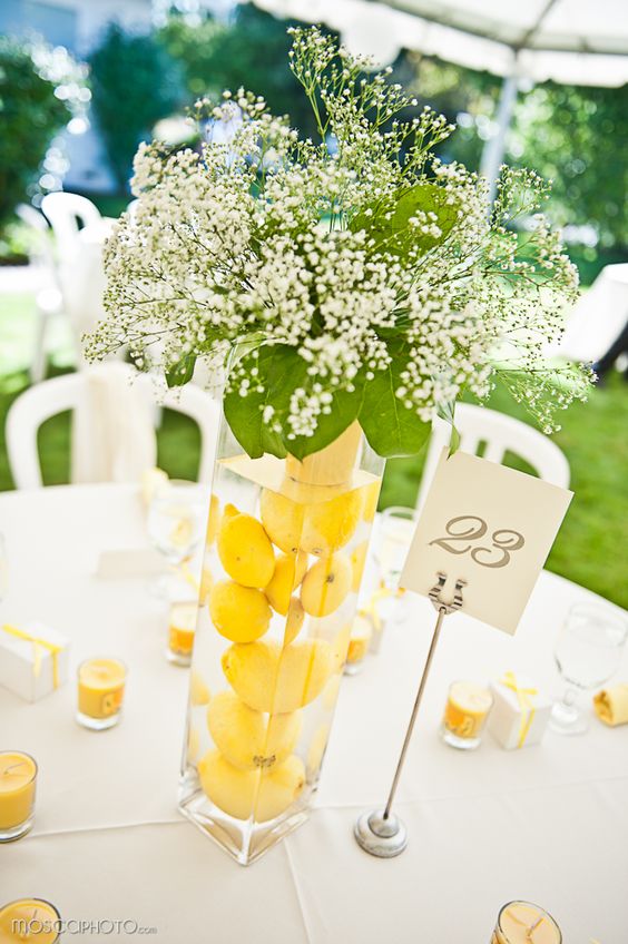 lemons submerged in water in tall vases as wedding CenterPieces
