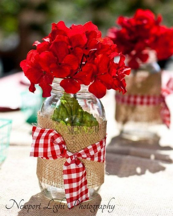 red flowers and mason jar wedding centerpiece