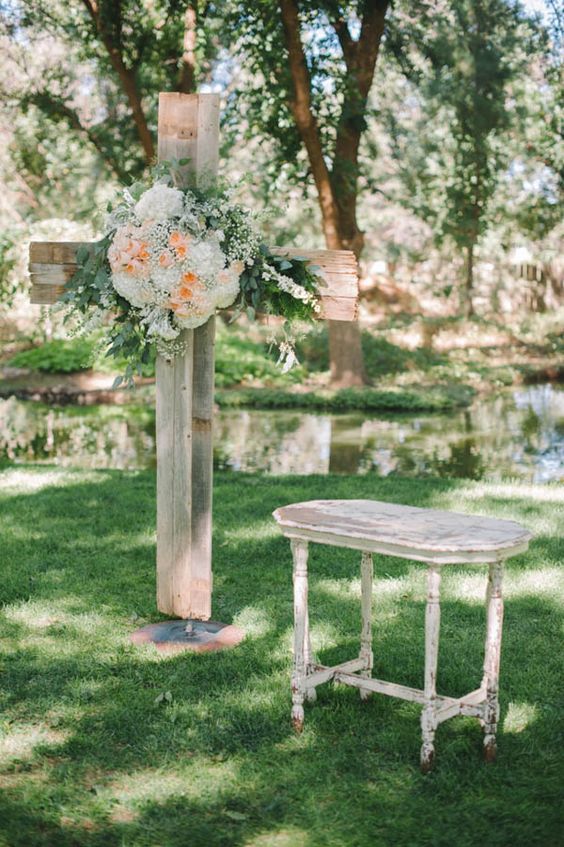 rustic cross with florals for wedding ceremony