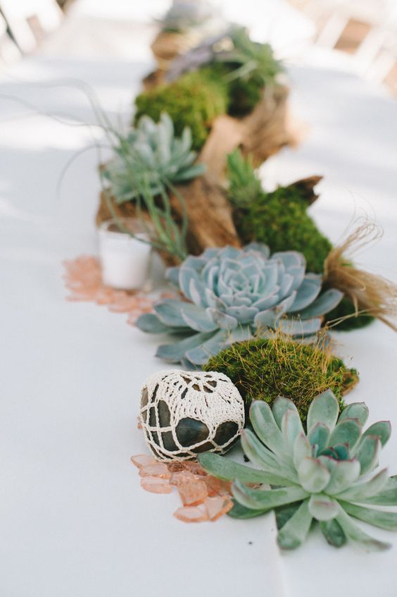 wrap rocks in doilies succulent and driftwood wedding centerpiece