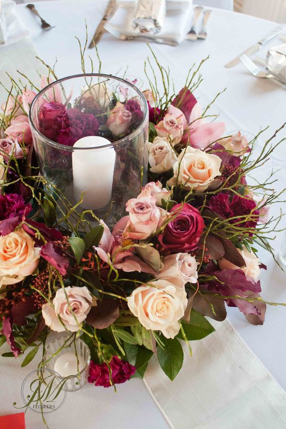 Burgundy and peach wedding table arrangements