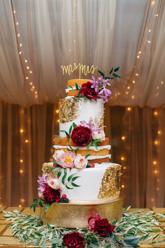 Half-naked, half-fondant cake dressed with gold foil, pink garden roses, marsala and pink peonies