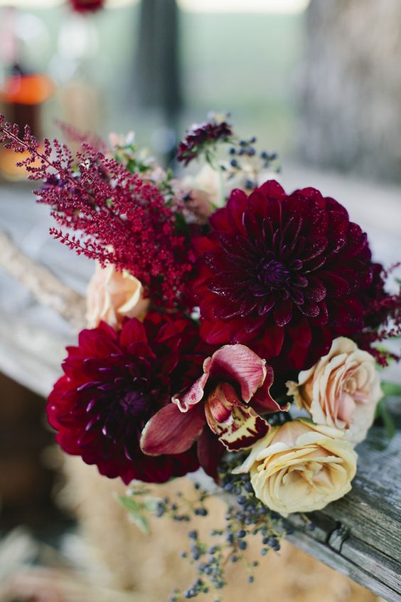 Red dahlias, yellow roses, orchids wedding bouquet
