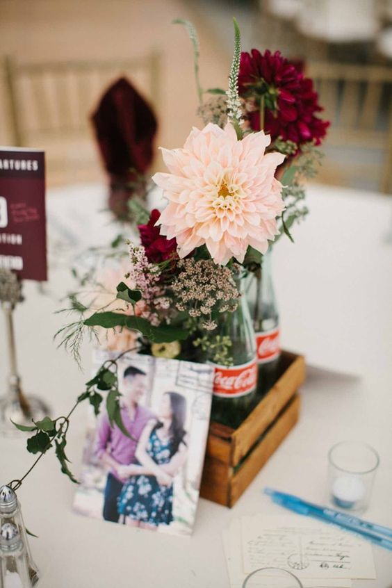 peach dalhia with rustic burgundy blooms in a coke bottle and crate