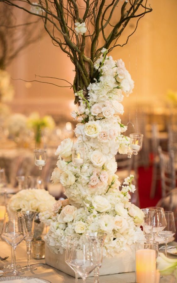 rustic white flowers tall wedding reception centerpiece idea via john cain photography