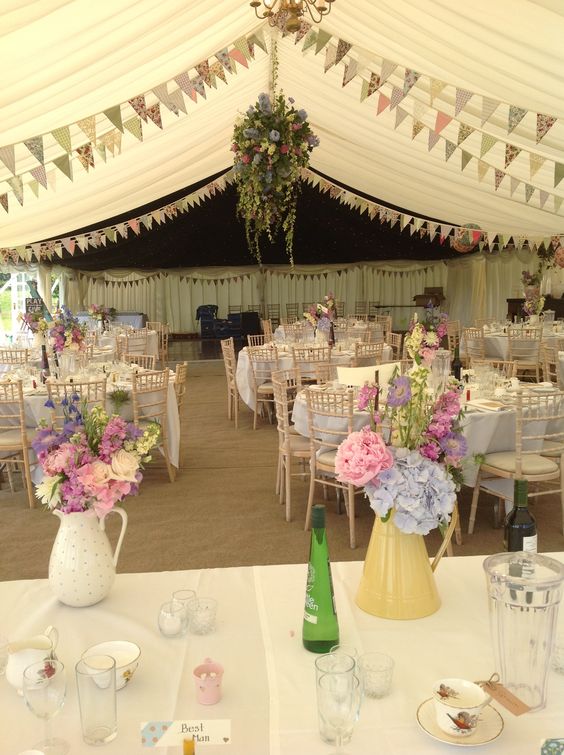 Summer flowers in pretty jugs wedding decor