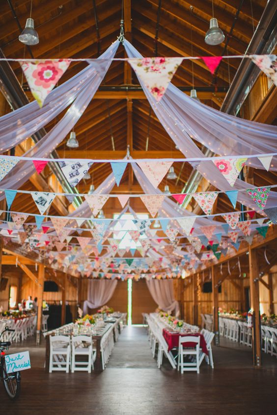 mismatched pattern bunting and long tables barn wedding decor